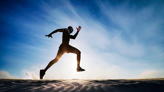 Man running on sand dunes.