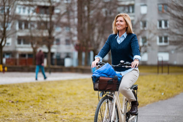 istock Woman riding a bicycle in a residential district 1212186839