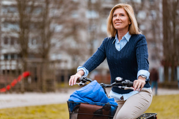istock Woman riding a bicycle in a residential district 1212186855