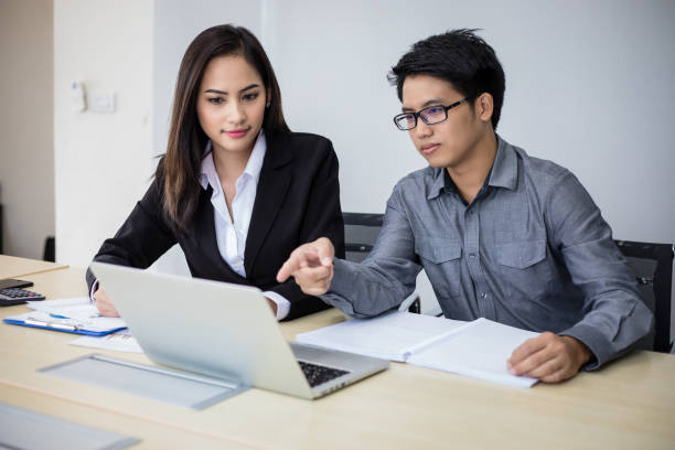 istock Asian businessmen and group using notebook for business partners discussing documents and ideas at meeting and business women smiling happy for working 1212187136