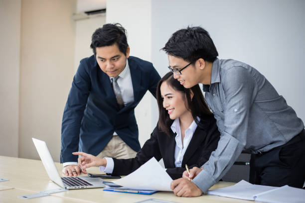 istock Asian businessmen and group using notebook for business partners discussing documents and ideas at meeting and business women smiling happy for working 1212187239