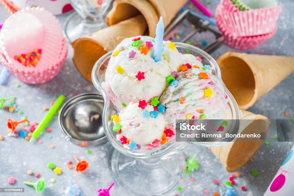 Birthday cake ice cream Colorful Birthday cake ice cream with Birthday decoration and ice cream waffle cones, white gray background copy space Ice Cream Stock Photo