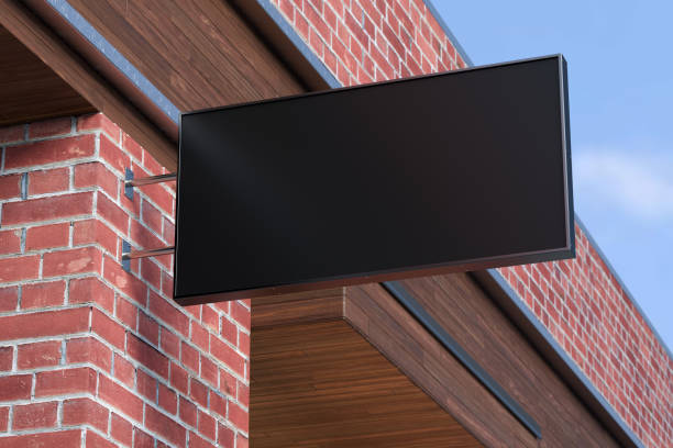 istock Horizontal signboard or signage on the red brick wall with blank black sign mock up. Bottom view. 1212190517