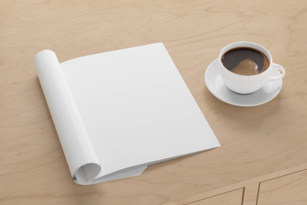 istock Blank magazine page. Workspace with folded magazine mock up on the desk. 1212190564