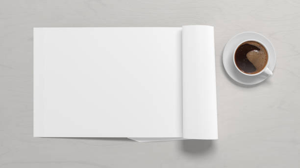 istock Blank magazine page. Workspace with folded magazine mock up on the desk. 1212190580
