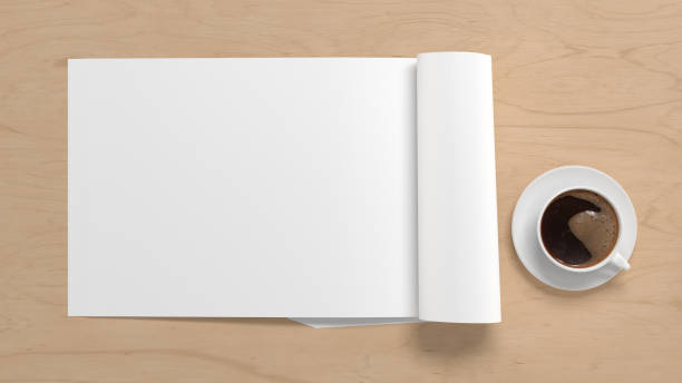 istock Blank magazine page. Workspace with folded magazine mock up on the desk. 1212190596