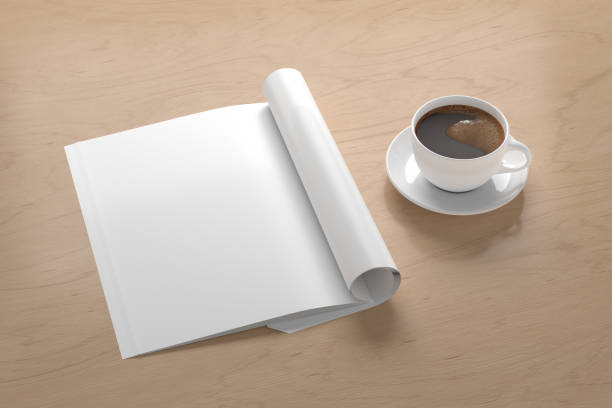 istock Blank magazine page. Workspace with folded magazine mock up on the desk. 1212190625