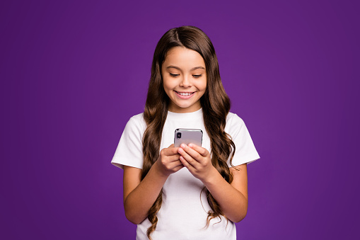Close-up portrait of her she nice attractive lovely cute cheerful cheery, wavy-haired girl using digital device 5g app isolated on bright vivid shine vibrant purple violet lilac color background