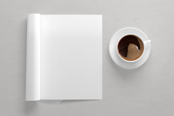 istock Blank magazine page. Workspace with folded magazine mock up on the desk. 1212190649