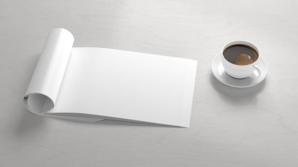 istock Blank magazine page. Workspace with folded magazine mock up on the desk. 1212190682