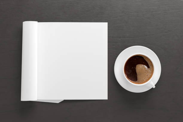 istock Blank magazine page. Workspace with folded magazine mock up on the desk. 1212191040