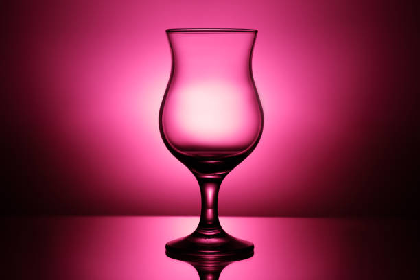 empty cocktail glass in pink background