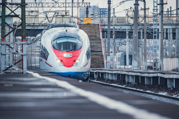 Highspeed train approaches to the station platform at winter day time.