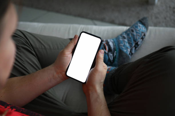 istock Male hand hold modern smartphone with blank scereen 1212193137