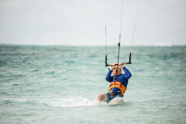 istock Kiteboard surfer gaining back control of kite. 1212196559