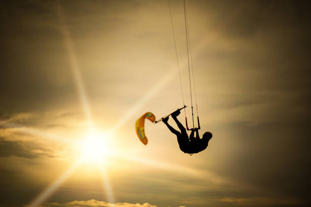 istock Kiteboarder performing stunts in the air on a beautiful sunset. 1212197451