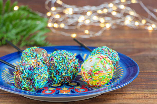 istock A colorful cake pops up, lying on a table. It is covered with sweet multi-colored sweets. Copy space 1212205399