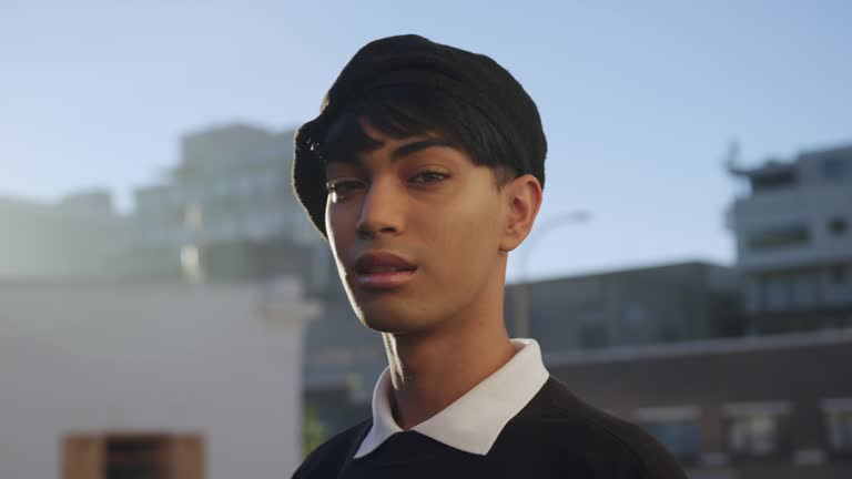 Transgender adult in the street smiling at the camera