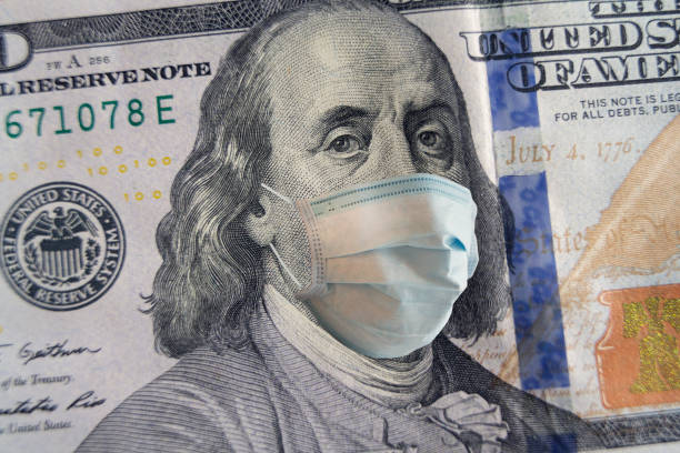 100 dollar banknote with a face mask. World crisis stock photo