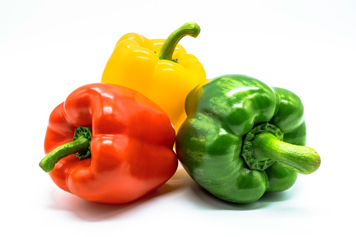 Red chilli, Green chillies, Yellow chillies, Three color bell pepper\nIsolated on white.