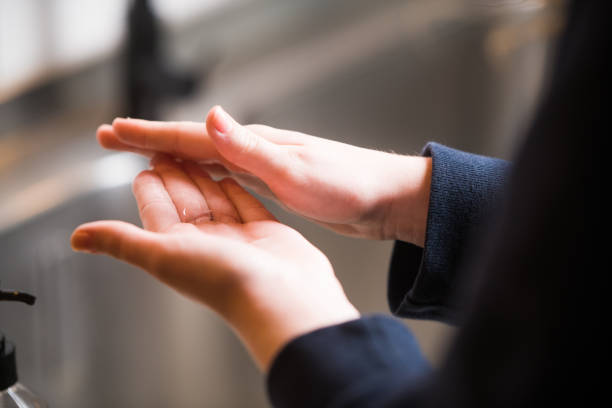 washing hands with sanitizer gel. putting lotion on hands. covid-19. corona - hand sanitizer liquid soap hygiene healthy lifestyle imagens e fotografias de stock