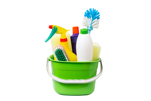 cleaning tools and products in bucket isolated on white background