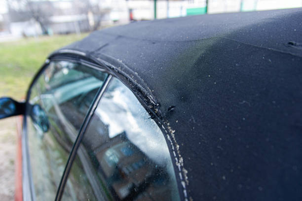 istock Convertible fabric roof repair, torn material, rubber seals. 1212211448