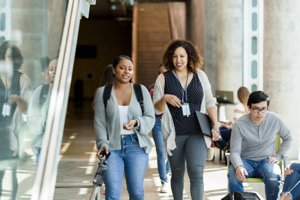 istock Female professor walks to class 1212211611