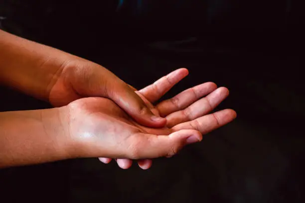 Photo of Massage the palm for the girl to relieve pain, Massage on palms to relieve aches, Side view