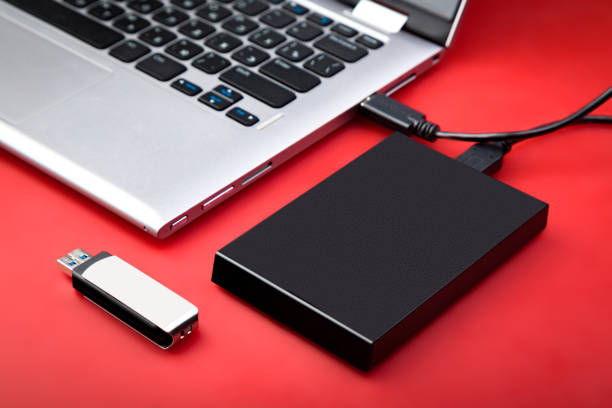 istock A portable hdd connected to a laptop with usb flash drive and smartphone 1212212124