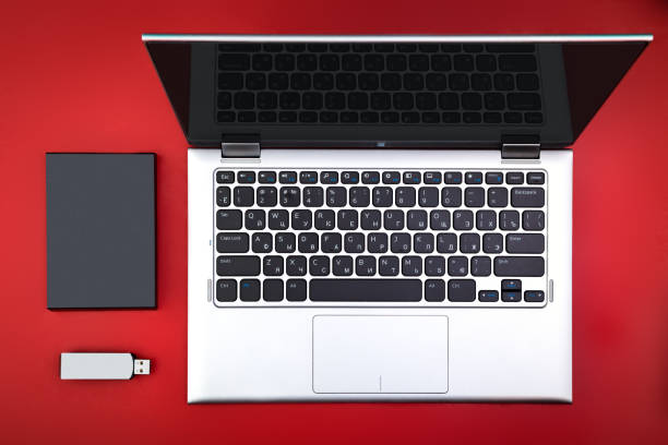 istock A flash drive, an external hard drive and an open laptop 1212212162