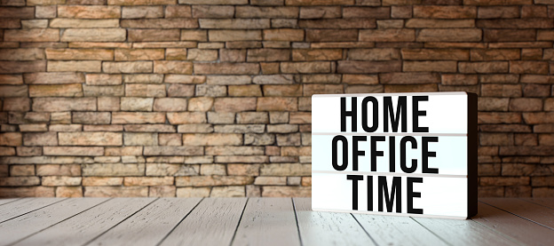 lightbox with text HOME OFFICE TIME in front of a brick wall - 3D rendered illustration