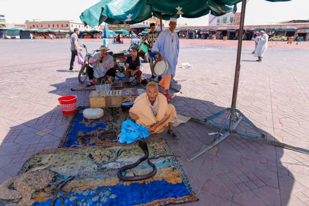 Marrakech, Marocco - February 20, 2024: man in traditional attire pours tea in the Agafay desert near Marrakech.
