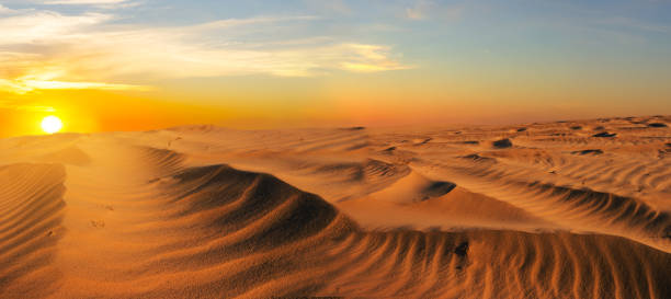 istock dramatic sunset over the wide sandy desert, good outdoor background 1212214335