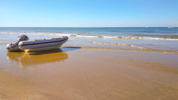 istock Rubber inflatable boat on the sandy seashore on a sunny day 1212214707