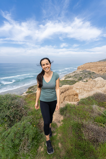 Young Hispanic Woman Hiking at Torrey Pines, San Diego, California.