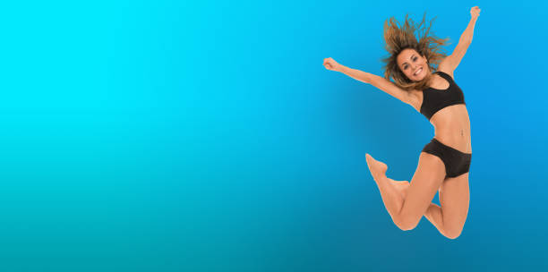 istock Young woman jumping  blue 1212217865