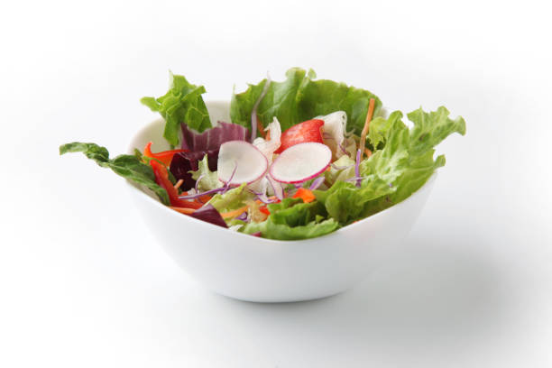 istock fresh green salad in bowl isolated on white background 1212217904