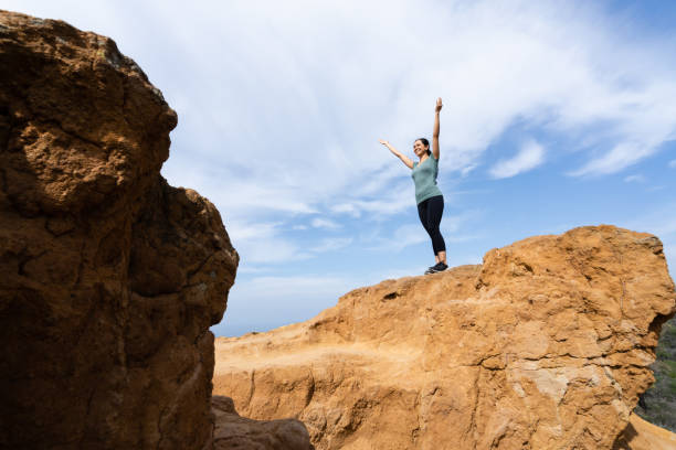 istock Young Hispanic Woman Hiker With Arms Raised 1212217962