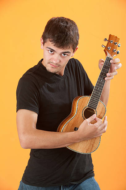 istock Serious Teen ukulele player 121222079