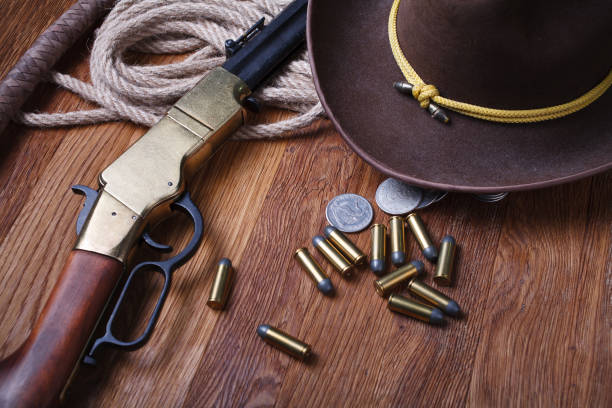 istock Wild west rifle, ammunition and silver dollars 1212221698