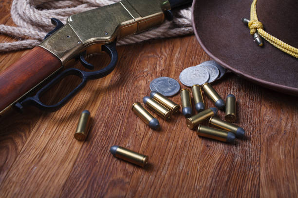 istock Wild west rifle, ammunition and silver dollars 1212221738