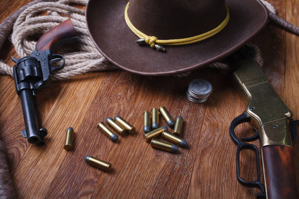 istock Wild west guns, ammunition and silver dollars 1212221747