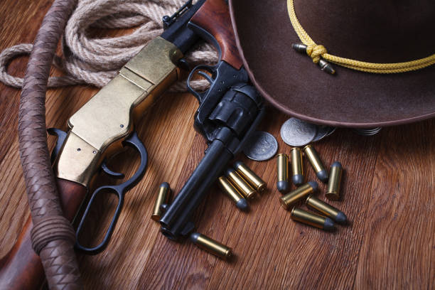 istock Wild west guns, ammunition and silver dollars 1212221782