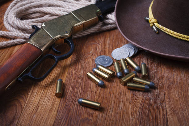 istock Wild west rifle, ammunition and silver dollars 1212221787