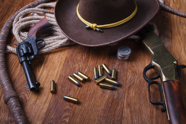 istock Wild west guns, ammunition and silver dollars 1212221802