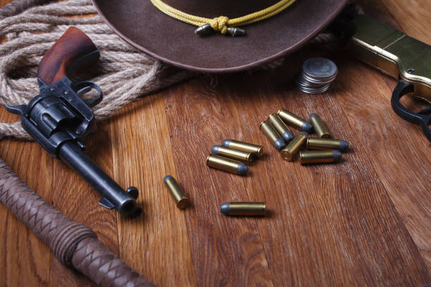 istock Wild west guns, ammunition and silver dollars 1212221823