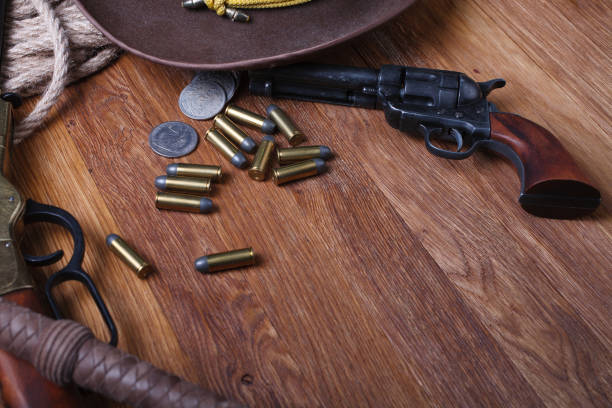 istock Wild west guns, ammunition and silver dollars 1212221873