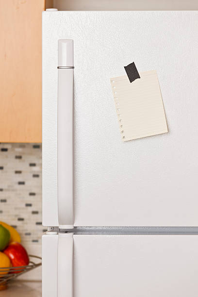 istock A magnet holding a note to a refrigerator door 121222189