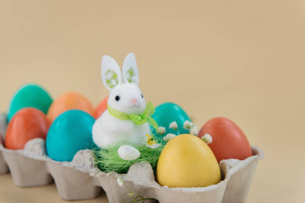 istock Easter concept with a bunny in nest. Painted easter eggs in egg 1212222517